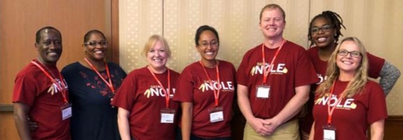 group of smiling educators with lanyards and badges